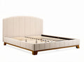 Upholstered queen size bed frame with wooden slats and soft beige fabric